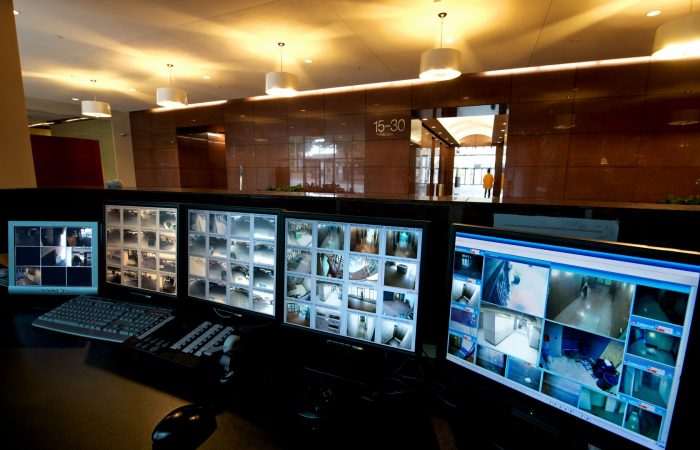 Bank of security monitors at the security desk in the lobby of a high-rise office building.